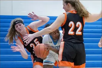  ?? Matt Freed/post-gazette ?? Latrobe's Camille Dominick and Anna Rafferty applied heavy Peyton Pinkney as the Wildcats took the Class 5A Section 4 pressure on Woodland Hills' title away from the Wolverines.