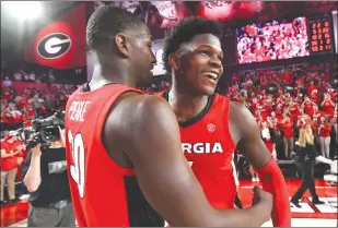  ?? Associated Press photo ?? In this Feb. 19 file photo, Georgia guard Anthony Edwards, right, and forward Mike Peake celebrate after an NCAA college basketball game against Auburn in Athens, Ga. Edwards was selected first overall Wednesday in the NBA draft.