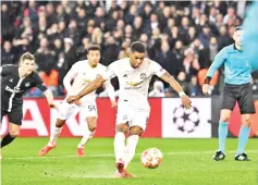  ??  ?? Manchester United's English forward Marcus Rashford scores a penalty during the UEFA Champions League round of 16 second-leg football match between Paris Saint-Germain (PSG) and Manchester United at the Parc des Princes stadium in Paris on March 6, 2019. - AFP photo