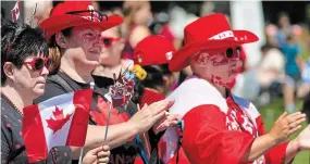  ?? ?? Friends Carolyn Smith, left, Tara Alrutz and Matthew Stewart get into the Canada Day spirit on Monday.