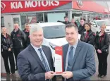  ??  ?? Alasdair Barnett with Jim Mackenzie, sales director, with some of the Kia team from Dicksons of Inverness.