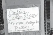  ??  ?? Sign on Carolyn Deal’s business Country Vapor warning of the broken window from an early morning earthquake in Harrah on July 15, 2014.