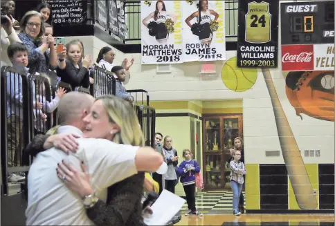  ?? Kevin Myrick / SJ ?? Caroline Williams Hipps hugs boys head coach Steve Luke during celebratio­ns retiring her number last Friday.