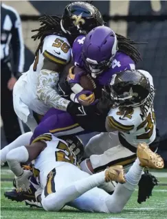  ?? FRANK AUGSTEIN/AP ?? The Vikings’ Dalvin Cook (running into a pack of Saints in London) isn’t up to his usual production this season but remains a danger.