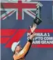  ?? ?? MCLAREN driver Lando Norris tosses his trophy on the podium after winning the Miami Grand Prix last Sunday. | AFP