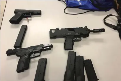  ?? CPD ?? Chicago police seized three guns during a traffic stop Thursday in the South Loop, which led to weapons charges against three men.