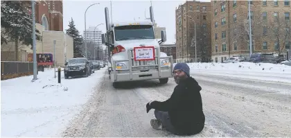  ?? ALEC SALLOUM ?? A man sat down on Victoria Avenue in front of one of the trucks in the protest convoy that rumbled through the downtown in Thursday.