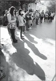  ?? NWA Democrat-Gazette/DAVID GOTTSCHALK ?? Susan Tucker (from left), a sophomore at the University of Arkansas from Little Rock, and Olivia Tzeng, a senior from Conway, observe a moment of silence Monday with others during the 9/11 Memorial Muslims for Life Peace Observance at the Fulbright...