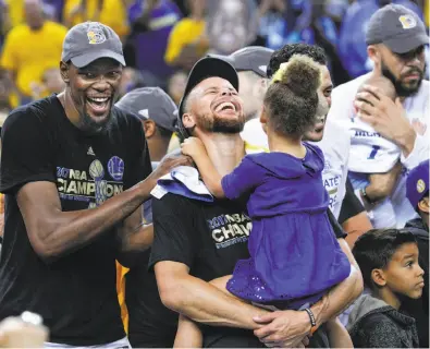  ??  ?? Confetti rains down on the court, above, after the Warriors beat back the challenge of the 2016 champion Cleveland Cavaliers in Game 5 to regain the title. Kevin Durant and Stephen Curry — holding daughter Riley — get the last laugh, left, while...