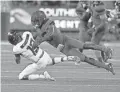  ?? RICK SCUTERI/AP ?? UA’s Demetrius Flannigan-Fowles (top) makes a tackle vs. Oregon on Oct. 27 in Tucson.