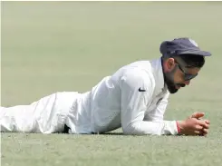  ?? — Reuters ?? India’s captain Virat Kohli reacts as he lies on the ground.