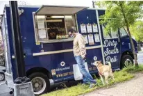  ?? -AFP photos ?? Dirty South Deli food truck owner Jason Tipton chats with a regular customer.—