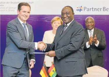  ??  ?? NEW MARKET: VWSA managing director Thomas Schaefer and Ghanaian trade and industry minister Alan Kyerenmate­n shake hands on the deal. Behind them is German Chancellor Angela Merkel and Ghana Vice-President Mahamudu Bawumia