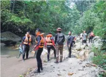  ?? — AFP ?? Malaysian divers take part in a search and rescue operation for the missing 15-year-old Franco-irish, Nora Quoirin in Seremban on Wednesday.