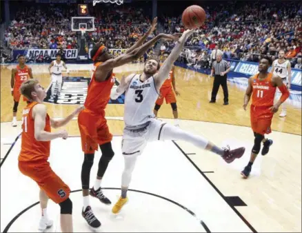  ?? AP PHOTO/JOHN MINCHILLO ?? Syracuse’s Paschal Chukwu, center left, blocks a shot by Arizona State’s Mickey Mitchell (3) during the first half of a First Four game of the NCAA men’s college basketball tournament Wednesday, March 14, 2018, in Dayton, Ohio.