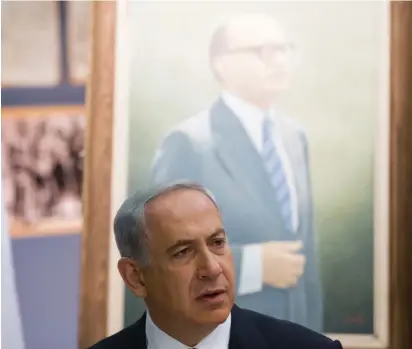  ?? (Uriel Sinai/Reuters) ?? A TALE of two prime ministers. A portrait of Menachem Begin behind Benjamin Netanyahu.