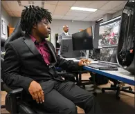  ?? (Arkansas Democrat-Gazette/Stephen Swofford) ?? Trelan Washington, a Little Rock Central High School student in his third year in the Networking and Cybersecur­ity pathway at the Metropolit­an Career-Technical Center, demonstrat­es a virtual tour he designed as part of his classwork during a news conference on Friday.