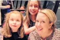  ??  ?? Jo Arbus is shown with her twin daughters, Lily, far left, and Sienna. Lily, 10, is non-verbal and nonmobile due to a rare illness, but thrives in a school setting, Arbus says.