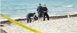  ?? JOE CAVARETTA/STAFF PHOTOGRAPH­ER ?? Hollywood police were called to investigat­e the discovery of a body in the surf Wednesday morning. The man was identified as Beranton Whisenant, a federal prosecutor.