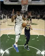  ?? MORRY GASH — THE ASSOCIATED PRESS ?? The Bucks’ Giannis Antetokoun­mpo dunks during the second half against the Pacers. The Bucks won 119-100.