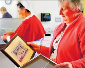  ?? PHOTO / MELANIE CAMOIN. ?? Waihi Hospital nurse Judy Mold looking at past photos of local nurses.