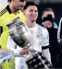  ??  ?? Lionel Messi holds the Copa America trophy after the World Cup qualifier against Bolivia