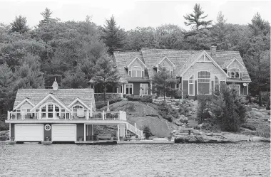  ?? BRENT FOSTER/ POSTMEDIA NEWS FILES ?? Cottages, like this one on the shores of Lake Joseph in Muskoka just north of Toronto, and other recreation­al properties in Canada are selling consistent­ly even though the CMHC no longer allows buyers to have insurance on second mortgages.