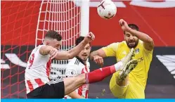  ?? — AFP ?? SHEFFIELD: Fulham’s Serbian striker Aleksandar Mitrovic (right) fouls Sheffield United’s English defender Jack Robinson (left) for a penalty to Sheffield during the English Premier League football match between Sheffield United and Fulham yesterday.