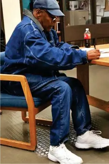  ??  ?? Free to go: OJ Simpson signs paperwork before leaving prison yesterday