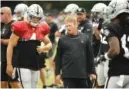  ?? THE ASSOCIATED PRESS ?? Oakland Raiders head coach Jon Gruden talks with quarterbac­k Derek Carr during practice Wednesday in Napa, Calif.