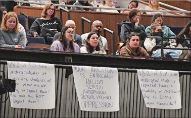  ?? DANA JENSEN/THE DAY ?? Connecticu­t College students listen Friday from the balcony where several banners were hanging with messages and questions for the Board of Trustees during their meeting in Palmer Auditorium on campus in New London.