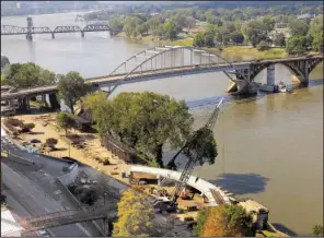  ?? Arkansas Democrat-Gazette/STEPHEN B. THORNTON ?? Ramp constructi­on (foreground) goes on near the Broadway Bridge over the Arkansas River on Thursday. The bridge will close this week for a scheduled six-month constructi­on of a new bridge.