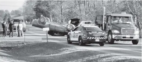  ?? [SUBMITTED] ?? Sawmill Road near Conestogo was closed briefly late Saturday afternoon following a two-vehicle collision that left a pickup truck on its roof.