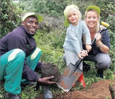  ?? PICTURE: ROY REED ?? North Coast resident Julia Uren and her son, Kyle, plant a tinderwood sapling together with Sibekezelo Masondo from the environmen­tal protection NGO, Wildlands.