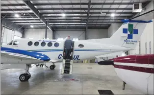  ?? NEWS PHOTOS GILLIAN SLADE ?? Above: The new fixed-wing air ambulance based in Medicine Hat is a Beechcraft King Air 250. Standing on the steps of the aircraft is Craig Ripley, the local base maintenanc­e engineer.