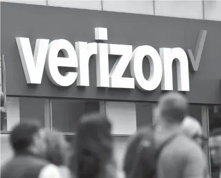  ?? Associated Press ?? ABOVE: Verizon corporate signage is captured May 2 on a store in Manhattan’s Midtown area, in New York.