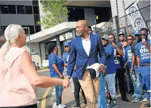  ?? /Alaister Russell/Sunday Times ?? Start talking: DA leader Mmusi Maimane greets party supporters outside the Hill on Empire building in Parktown, Johannesbu­rg. He was attending the Zondo commission of inquiry into state capture on Thursday, and called on ANC leaders implicated in state capture to testify before the commission.