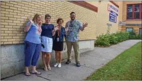  ?? CARLY STONE - MEDIANEWS GROUP ?? From left to right: Teacher Aid Amy Bishop, AIS Teacher Chris Hawthorne, Teacher Aid Alicia Alberson, and Librarian Mike Finnerty wait to welcome students back to North Broad Elementary on Tuesday, September 7, 2021.