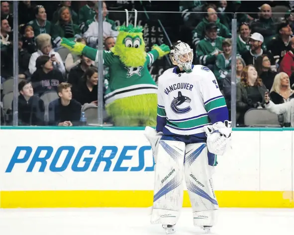 ?? — THE ASSOCIATED PRESS FILES ?? Above, Stars mascot Victor E Green reacts to a call of no goal, after video review, as Canucks goalie Jacob Markstrom looks on during an NHL game in Dallas on Feb. 11. Ensuring consistenc­y in video reviews is anything but simple, Ed Willes writes.
