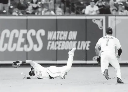  ?? JULIO CORTEZ/AP ?? Orioles left fielder DJ Stewart gets hit by the ball as he fails to make a catch last week in a game against the Yankees.