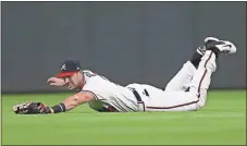  ?? John Bazemore / The Associated Press ?? Atlanta Braves center fielder Lane Adams makes a diving catch during Wednesday’s game against the Washington Nationals.