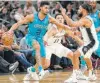  ?? Darren Abate / Associated Press ?? The Hornets’ Jeremy Lamb, left, tangles with the Spurs’ Patty Mills, right, and Bryn Forbes during the second half.