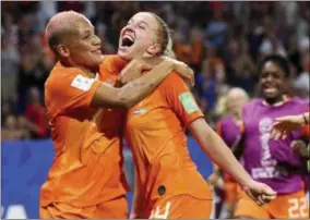  ?? FRANCISCO SECO - THE ASSOCIATED PRESS ?? Netherland­s’ Jackie Groenen, is congratula­ted by teammate Shanice Van De Sanden, left, after scoring during the Women’s World Cup semifinal soccer match between the Netherland­s and Sweden, at the Stade de Lyon outside Lyon, France, Wednesday, July 3, 2019.