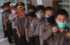  ??  ?? Children wear masks at a kindergart­en in Jakarta, Indonesia