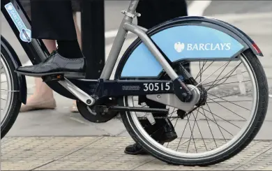 ?? PHOTO: REUTERS ?? A worker rides a public hire bike, sponsored by Barclays, in the City of London yesterday. The second-biggest British bank said its first-half earings after tax rose 68 percent, but it suffered a 50 percent fall in second-quarter pretax profit at the...