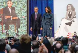  ?? | ANDREW HARNIK/ AP ?? Former President Barack Obama and former first lady Michelle Obama stand on stage Monday at the unveiling of their official portraits at the Smithsonia­n’s National Portrait Gallery inWashingt­on, D. C.