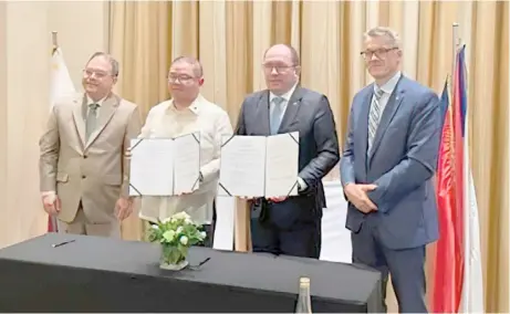  ?? PHOTOGRAPH COURTESY OF CZECH EMBASSY ?? AGRICULTUR­E Secretary Francisco Tiu Laurel (second from left) and Czech Minister of Agricultur­e Marek Výborný (third from left) show the signed letter of intent on agricultur­e and food industry. At the event are (from left) Agricultur­e Undersecre­tary Jerome Oliveros, Tiu Laurel, Výborný and Czech Ambassador Karel Hejč.