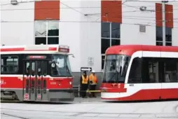  ?? RANDY RISLING/TORONTO STAR ?? Once the pre-inspection of a new streetcar is complete, an older model streetcar is used to tow it to the Hillcrest facility.
