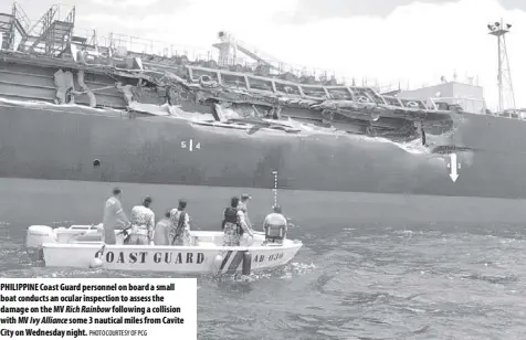  ?? PHOTO COURTESY OF PCG ?? PHILIPPINE Coast Guard personnel on board a small boat conducts an ocular inspection to assess the damage on the MV Rich Rainbow following a collision with MV Ivy Alliance some 3 nautical miles from Cavite City on Wednesday night.