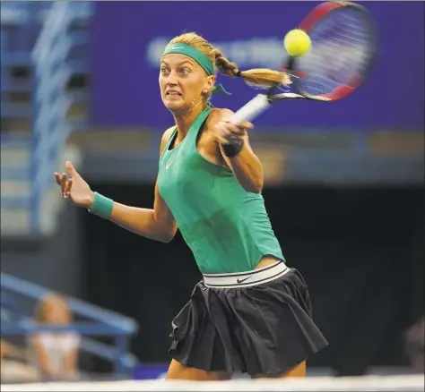  ?? Brian A. Pounds / Hearst Connecticu­t Media ?? Three-time champion Petra Kvitova charges the net to hit a forehand winner in her opening round match against Agnieszka Radwanska at the Connecticu­t Open Monday in New Haven.